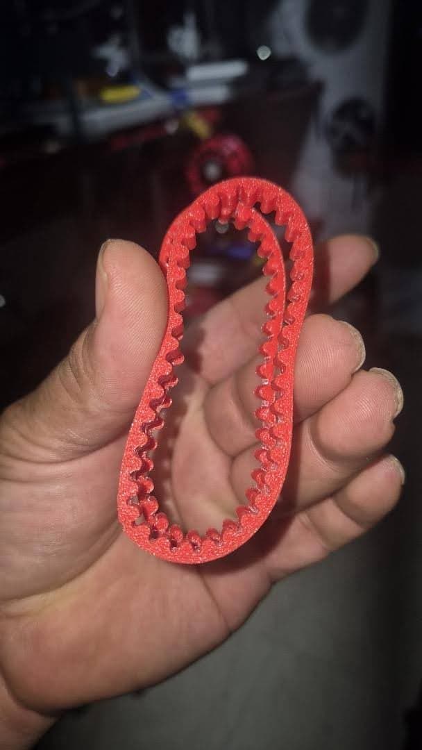 Red flexible belt test print held in a hand